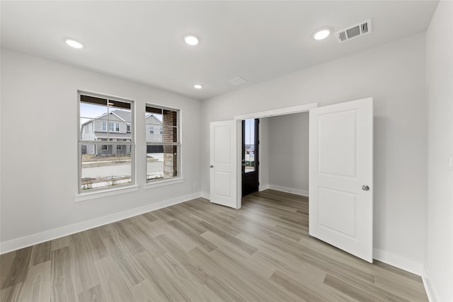 spare room featuring light hardwood / wood-style flooring