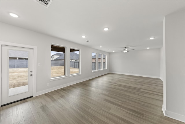 empty room featuring wood-type flooring and ceiling fan