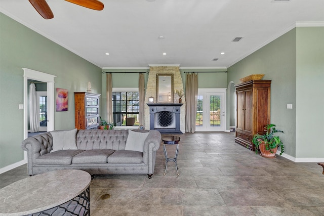 living room featuring a fireplace, plenty of natural light, crown molding, and ceiling fan