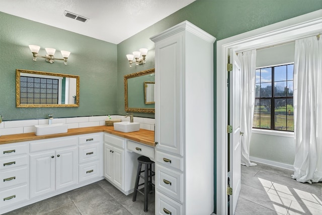 bathroom with tile patterned floors and vanity