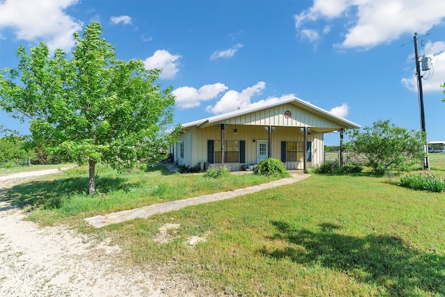 view of front of house with covered porch and a front yard