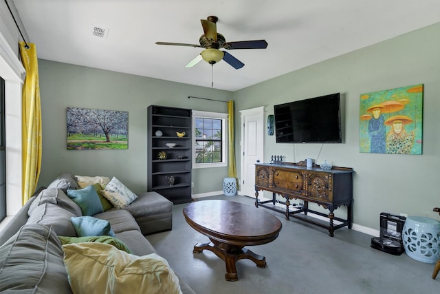 living room with concrete flooring and ceiling fan