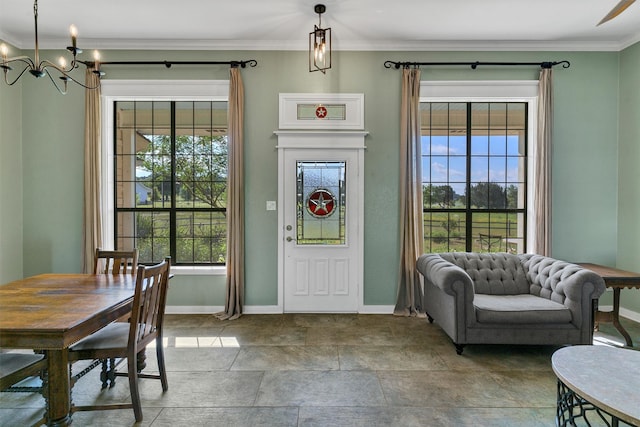 foyer featuring plenty of natural light and crown molding