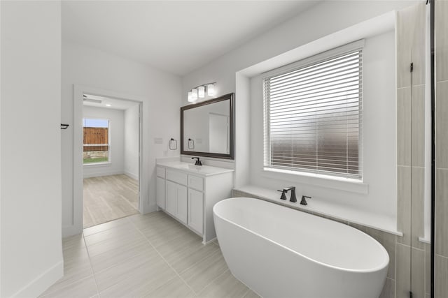 bathroom featuring a bath, wood-type flooring, and vanity