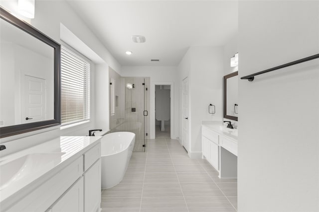 bathroom with plus walk in shower, vanity, and tile flooring