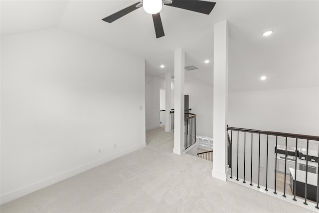 carpeted empty room featuring ceiling fan and vaulted ceiling