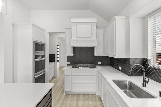 kitchen featuring plenty of natural light, tasteful backsplash, stainless steel appliances, and white cabinetry