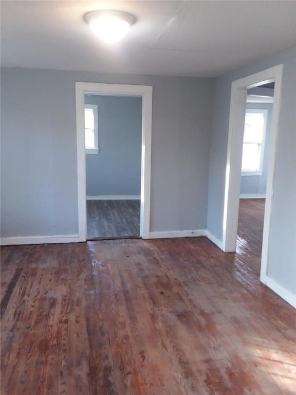 spare room featuring dark hardwood / wood-style flooring