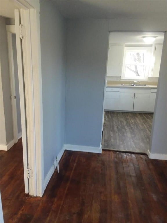 hall with dark hardwood / wood-style flooring and sink