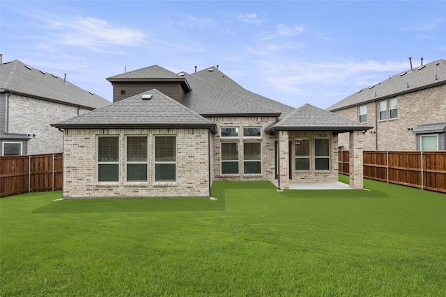 back of property featuring a patio and a lawn