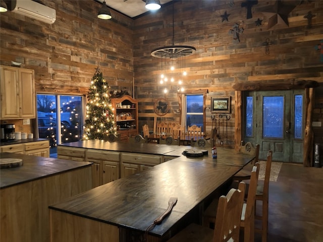 bar with a wall unit AC, a towering ceiling, butcher block counters, wood walls, and decorative light fixtures