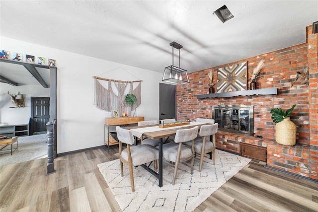 dining area with a fireplace and hardwood / wood-style flooring