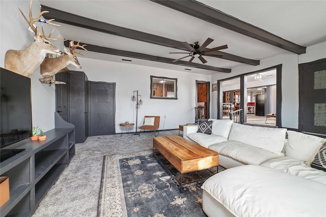 living room featuring carpet flooring, beam ceiling, and ceiling fan