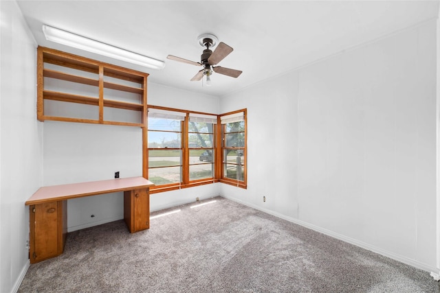 unfurnished office with ceiling fan and light carpet