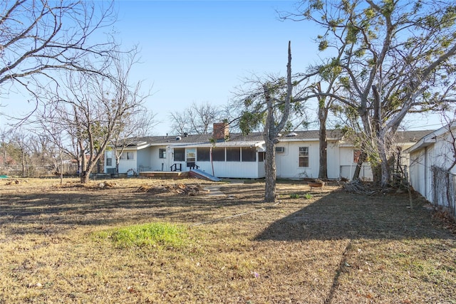 back of house with a lawn