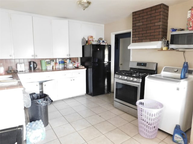 kitchen with gas stove, fume extractor, tasteful backsplash, white cabinetry, and black fridge