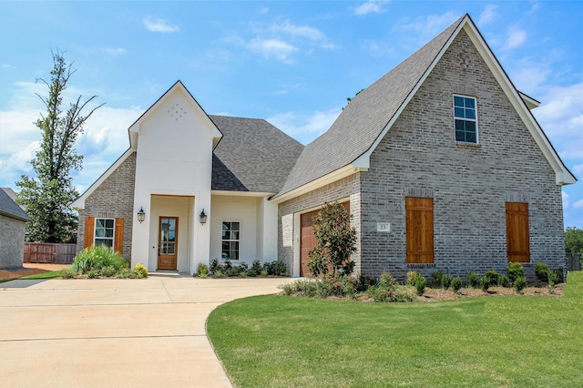 view of front of home with a garage and a front lawn