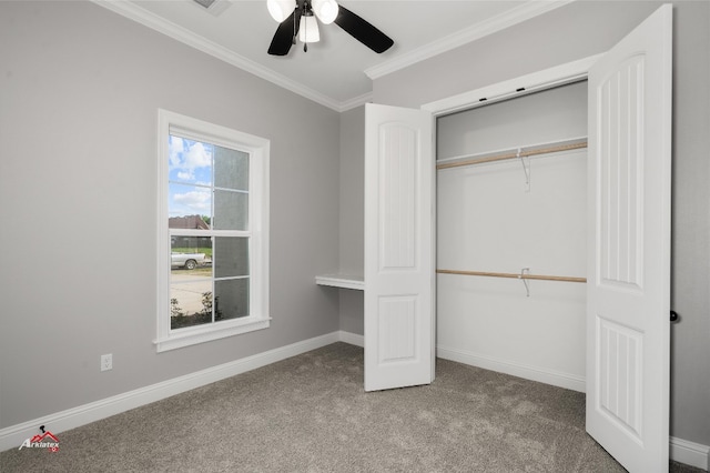 unfurnished bedroom featuring ornamental molding, carpet, ceiling fan, and a closet