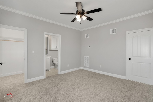 unfurnished bedroom featuring crown molding, a closet, and light carpet