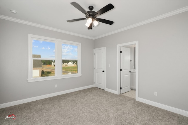 unfurnished bedroom with crown molding, light carpet, ceiling fan, and ensuite bathroom