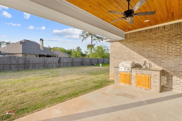 view of patio with ceiling fan, area for grilling, and sink