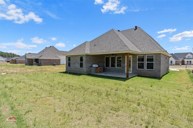 back of house with a lawn and a patio area