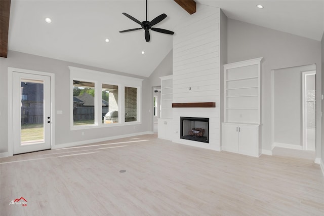 unfurnished living room featuring high vaulted ceiling, a fireplace, beamed ceiling, ceiling fan, and light wood-type flooring