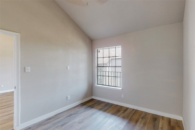 empty room featuring light hardwood / wood-style floors and vaulted ceiling