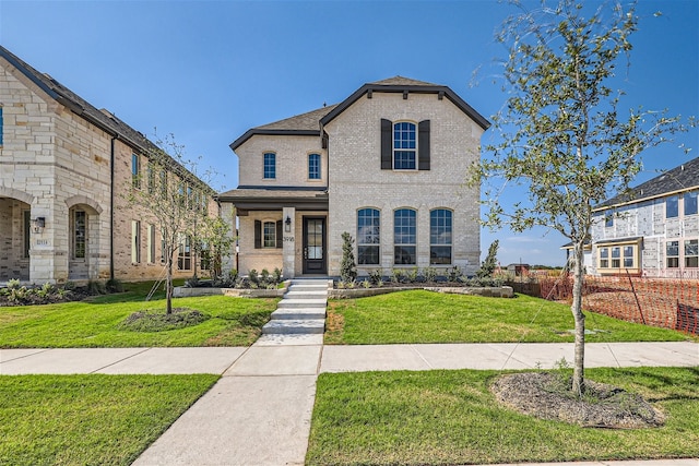 french country style house with a front lawn