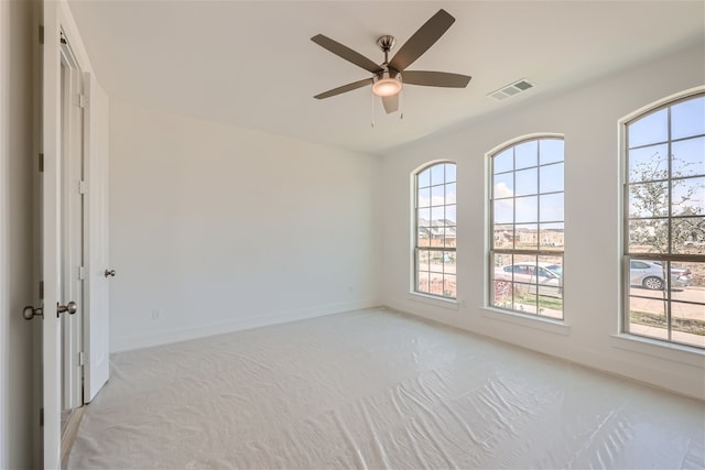 carpeted spare room with ceiling fan