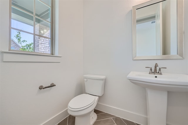 bathroom with toilet and tile patterned flooring