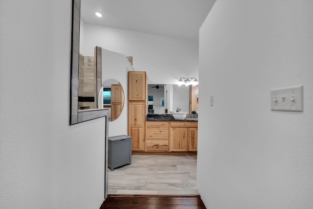 hall featuring sink, a barn door, and hardwood / wood-style flooring