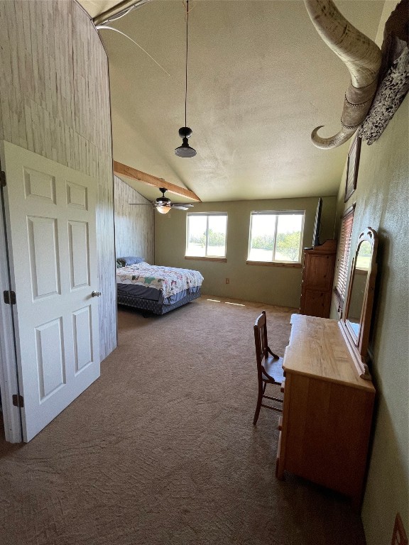 unfurnished bedroom with vaulted ceiling, a textured ceiling, and carpet flooring