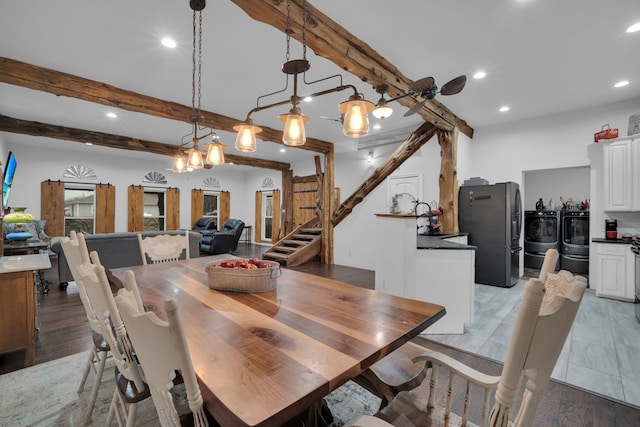 living room featuring a healthy amount of sunlight, dark wood-type flooring, beamed ceiling, and a barn door