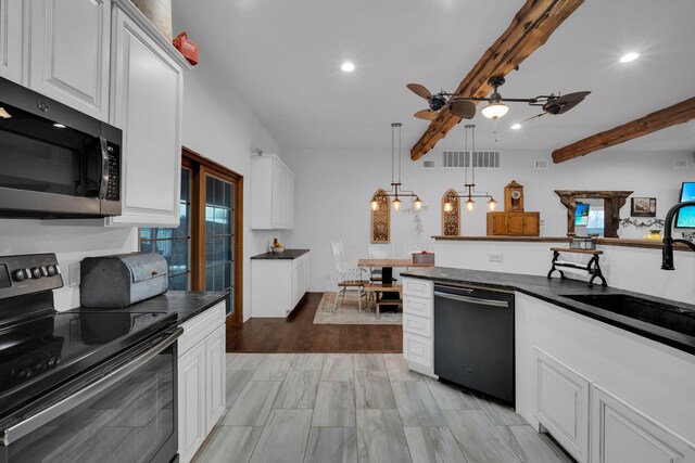 dining room with washer and clothes dryer, beamed ceiling, and light wood-type flooring