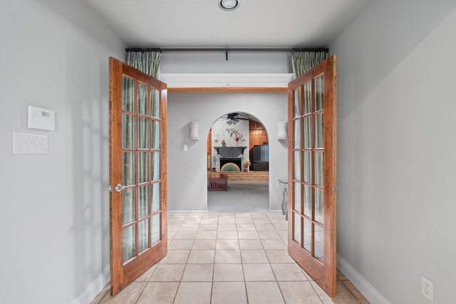 hall with light tile floors and french doors