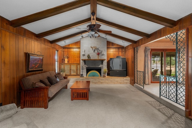 living room featuring vaulted ceiling with beams, ceiling fan, a fireplace, light carpet, and wooden walls