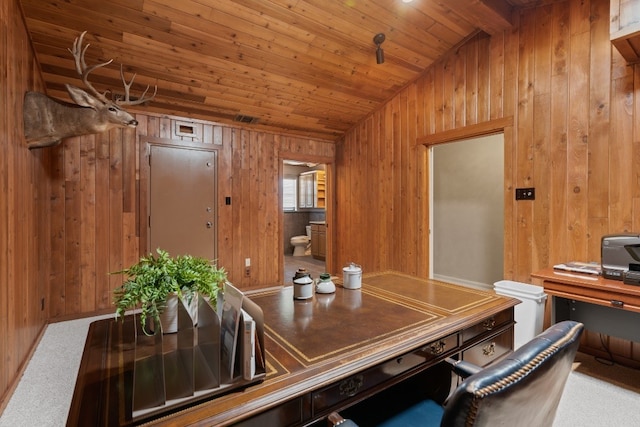 carpeted home office featuring wood walls and wooden ceiling