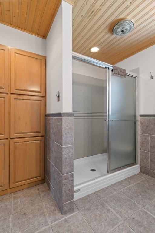 bathroom featuring tile walls, wooden ceiling, a shower with door, and tile flooring