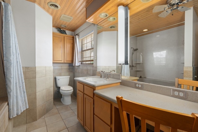 full bathroom with toilet, large vanity, ceiling fan, tile walls, and tile floors