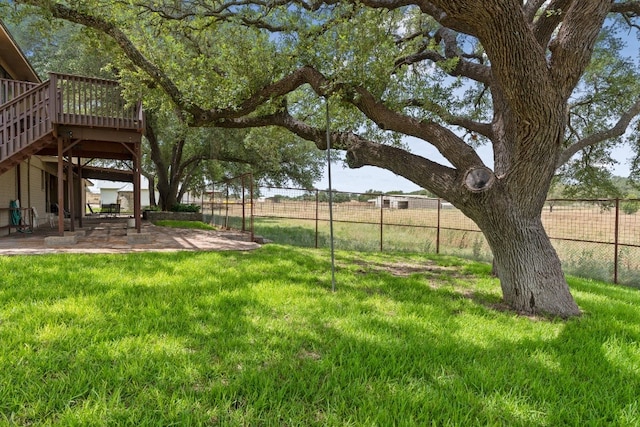 view of yard with a deck and a patio