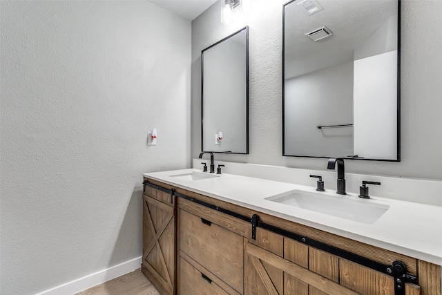 bathroom with wood-type flooring and vanity