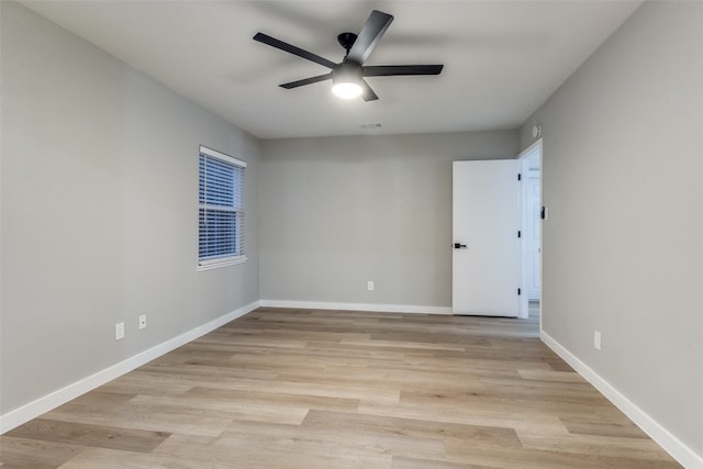 empty room featuring light wood-type flooring and ceiling fan