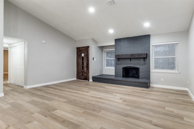 unfurnished living room featuring a fireplace and light hardwood / wood-style flooring