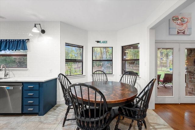 dining room featuring sink and light hardwood / wood-style flooring