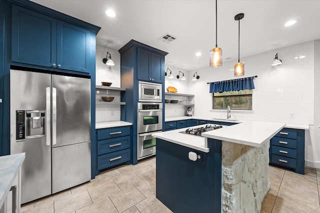 kitchen featuring a kitchen island, hanging light fixtures, stainless steel appliances, backsplash, and blue cabinetry