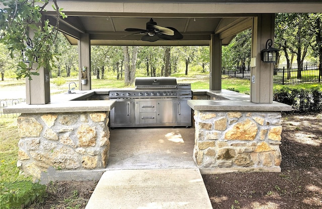 view of patio / terrace featuring ceiling fan and an outdoor kitchen