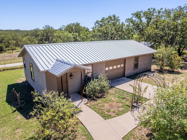 single story home with an outdoor structure, a front yard, and a garage