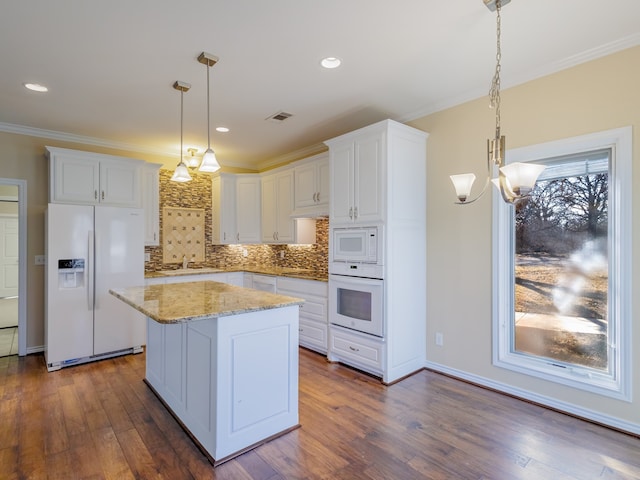 kitchen with white cabinets, white appliances, dark hardwood / wood-style floors, and decorative light fixtures