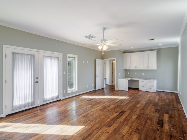 unfurnished living room featuring ceiling fan, dark hardwood / wood-style floors, and built in desk